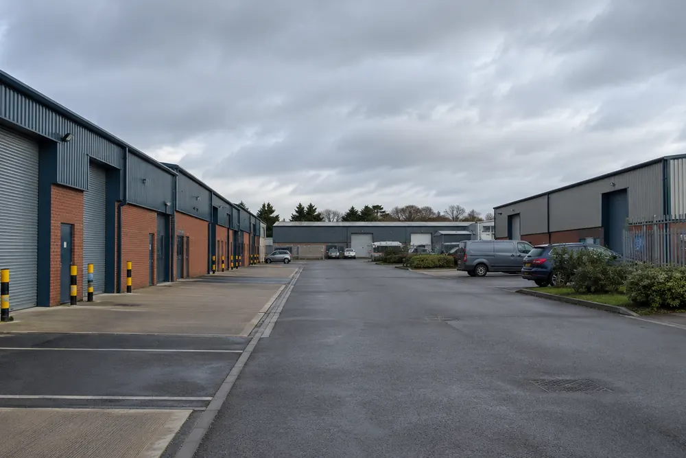 Brick industrial units and roller shutters at a West Midlands style industrial estate